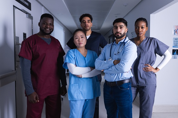Portrait of diverse male and female doctors standing together - Heart to Heart Hospice team